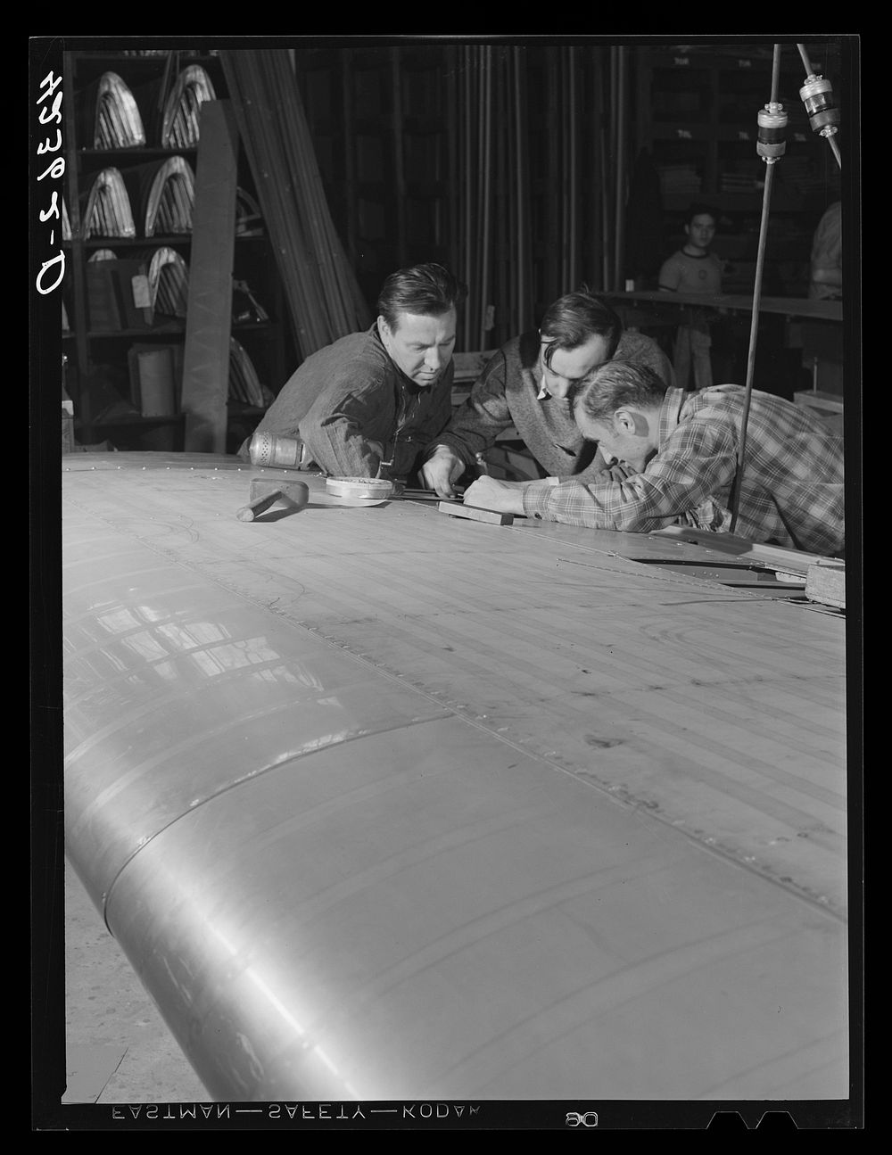 Working on an aileron assembly of a wing at the Vought Sikorsky Aircraft Corporation. Stratford, Connecticut. Sourced from…