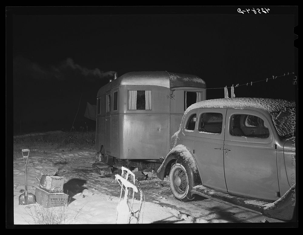 Trailer and car occupied by Mr. and Mrs. Clyde Burton (refer to caption #42581). Bath, Maine. Sourced from the Library of…