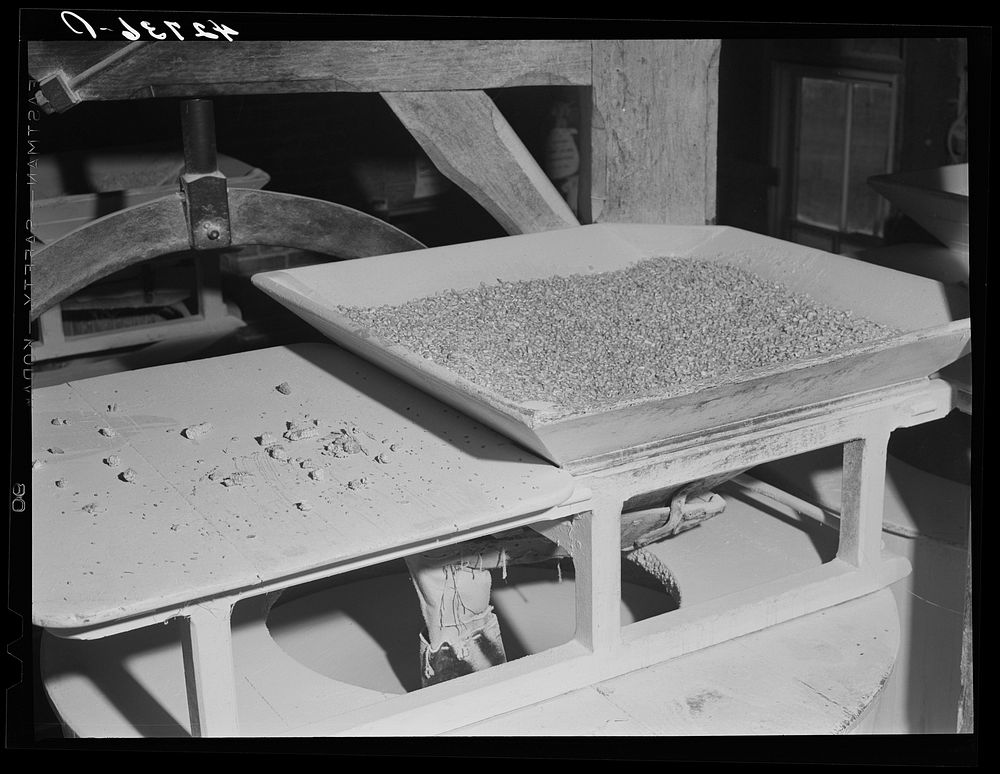 Corn over the grinding stone in Kenyon's johnnycake flour mill in Usquepaugh, Rhode Island. Sourced from the Library of…