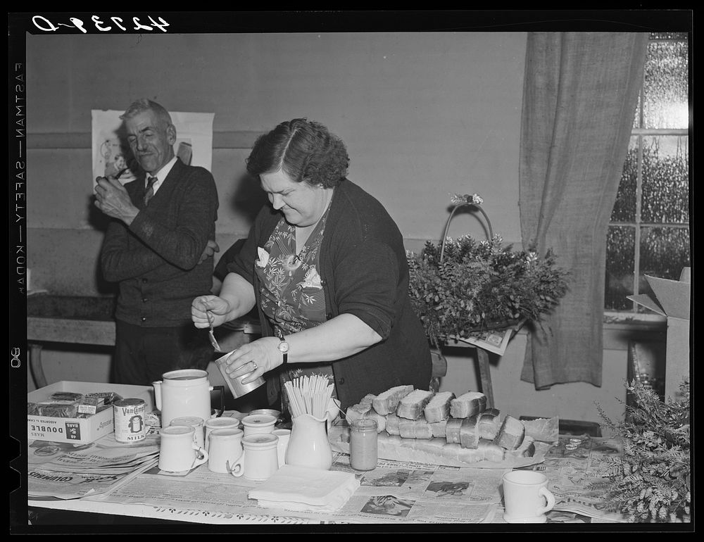 Mrs. Tucker, wife of the town police chief, preparing hot dogs and coffee at a Saturday night square dance in Clayville…