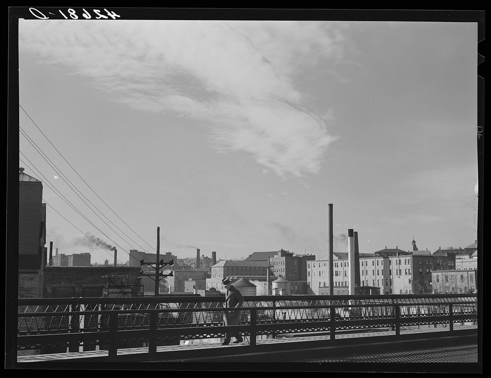 [Untitled photo, possibly related to: Textile mills seen from a bridge in Woonsocket, Rhode Island]. Sourced from the…