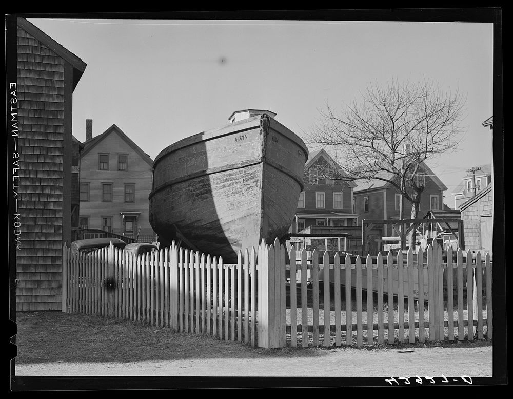 A boat in backyard of house along the waterfront in New Bedford, Massachusetts. Sourced from the Library of Congress.