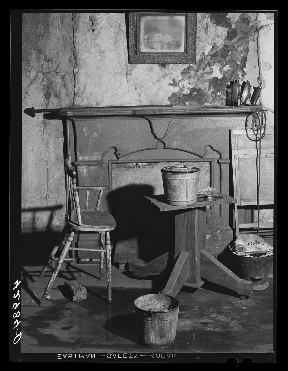 [Untitled photo, possibly related to: Buckets placed in room to catch water from leaky ceiling in a house in Mount…