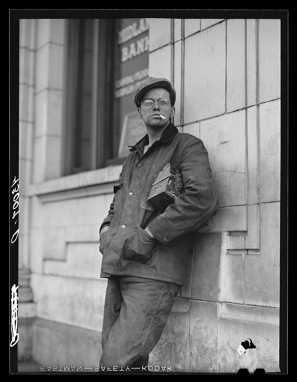 Steelworker waiting for a bus Midland, Pennsylvania. Sourced from the Library of Congress.