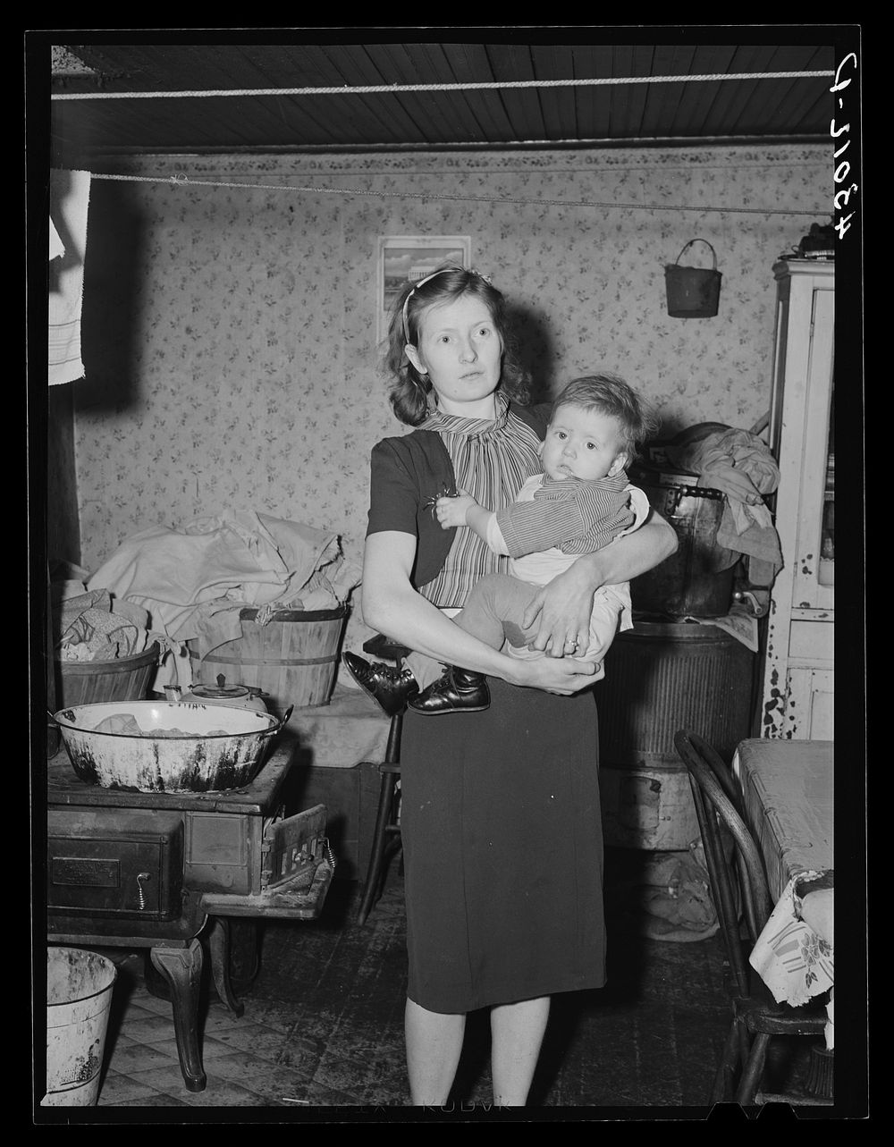 Woman and her child living in slum house in Bridgewater, Pennsylvania. Her husband is a steelworker. Sourced from the…