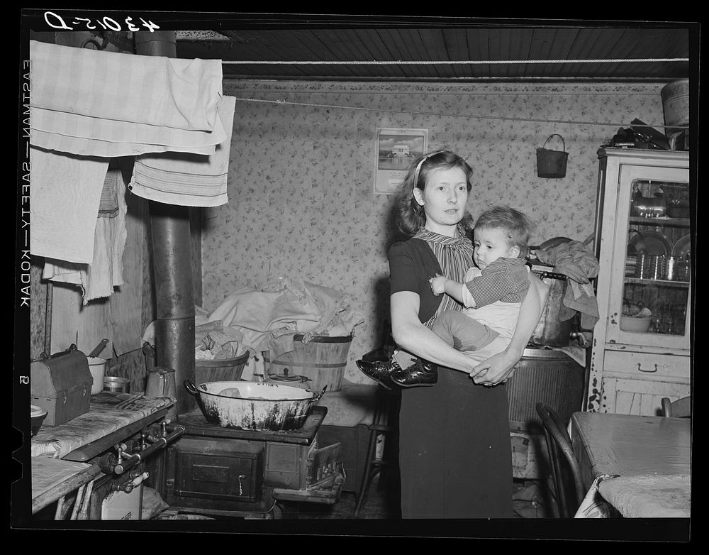 Woman and her child living in a slum house in Bridgewater, Pennsylvania. Her husband is a steelworker. Sourced from the…