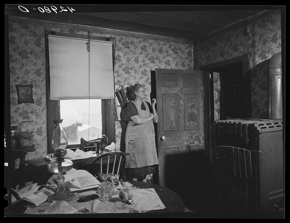 Woman in dilapidated old house in the Mount Washington district of Beaver Falls, Pennsylvania. She is blind in one eye and…