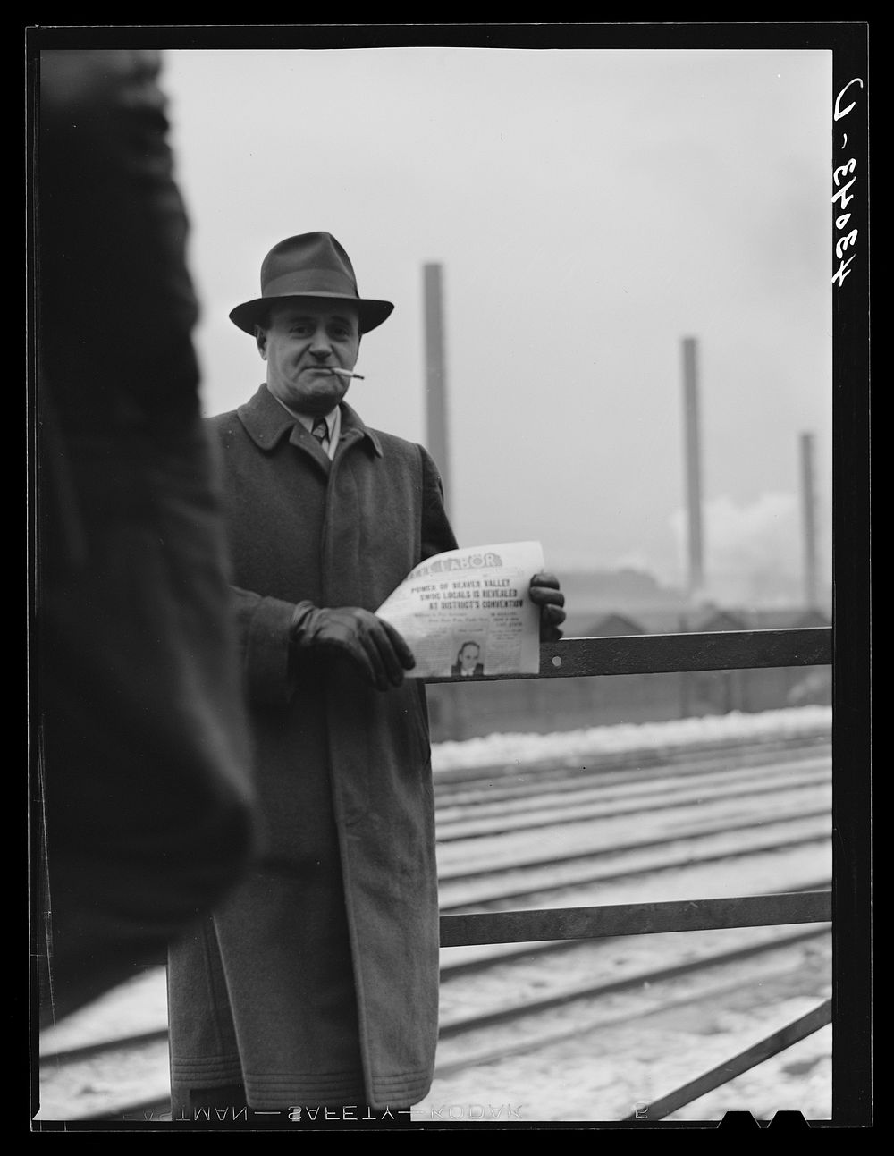 [Untitled photo, possibly related to: Union member distributing "Steel Labor" near the entrance the the Jones and Laughlin…
