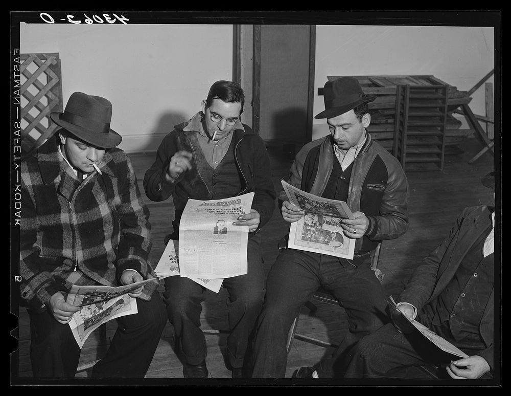 Union members reading "Steel Labor" at the union hall in Midland, Pennsylvania. Sourced from the Library of Congress.