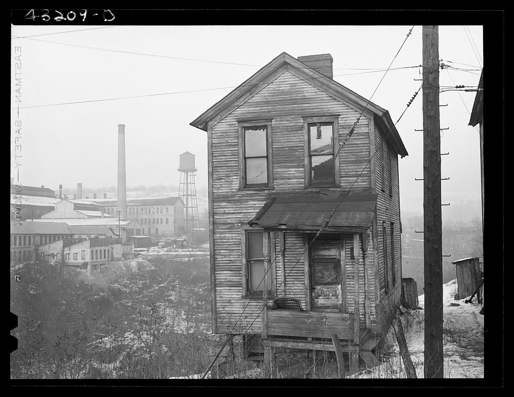 [Untitled photo, possibly related to: One of the houses in the  quarter of Rochester, Pennsylvania. Abandoned glass works in…