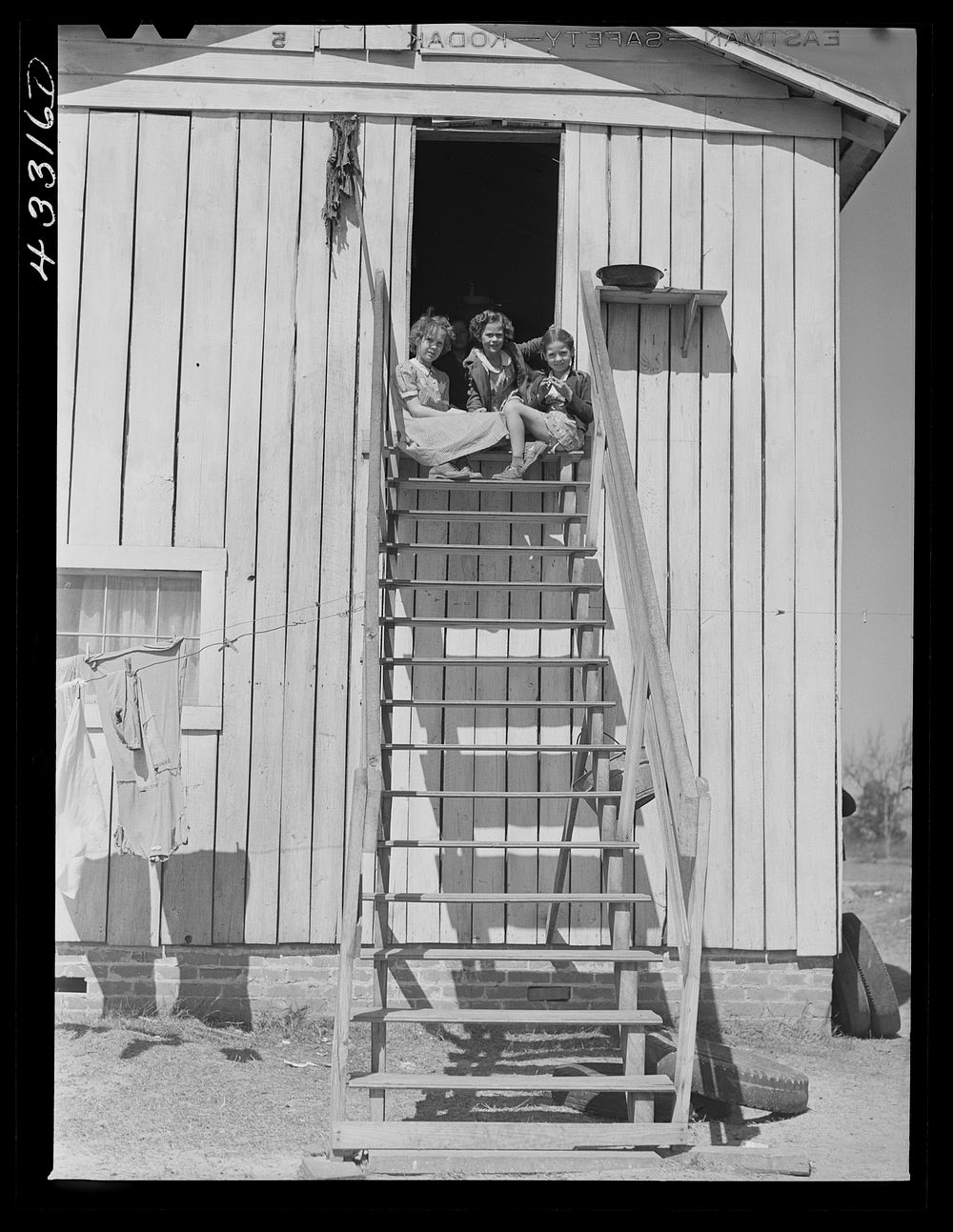 Children of workers from Fort Bragg living in a tobacco barn converted into living quarters near Fayetteville, North…