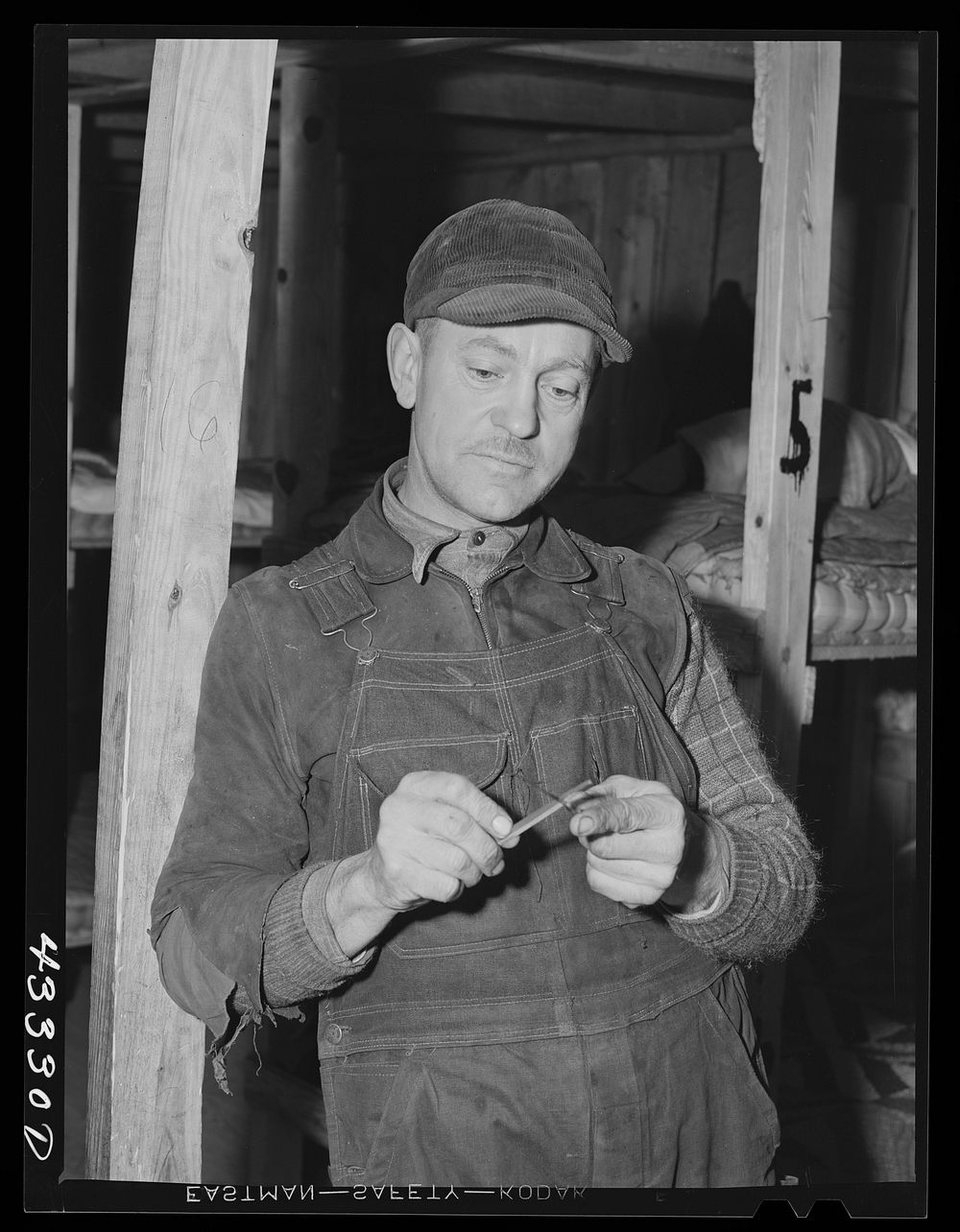 Silver Lake (vicinity), North Carolina. A worker who is employed at Fort Bragg in the doorway of a bunkerhouse in which he…