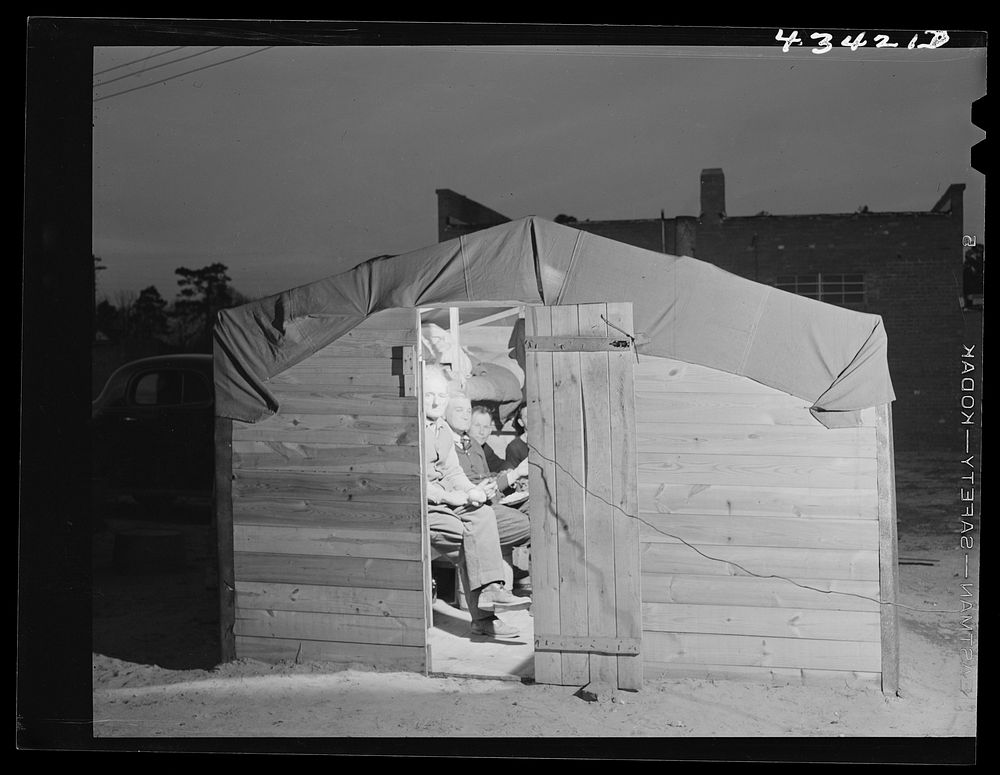 Bunkhouse in a settlement of construction workers who work at Fort Bragg. Near Fayettevellie, North Carolina. Sourced from…