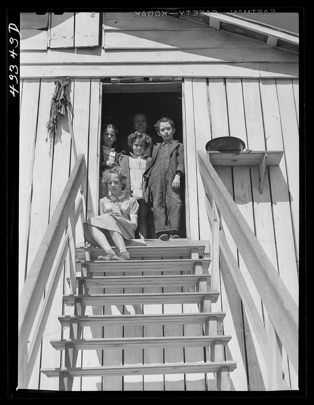[Untitled photo, possibly related to: Children of workers from Fort Bragg living in a tobacco barn converted into living…