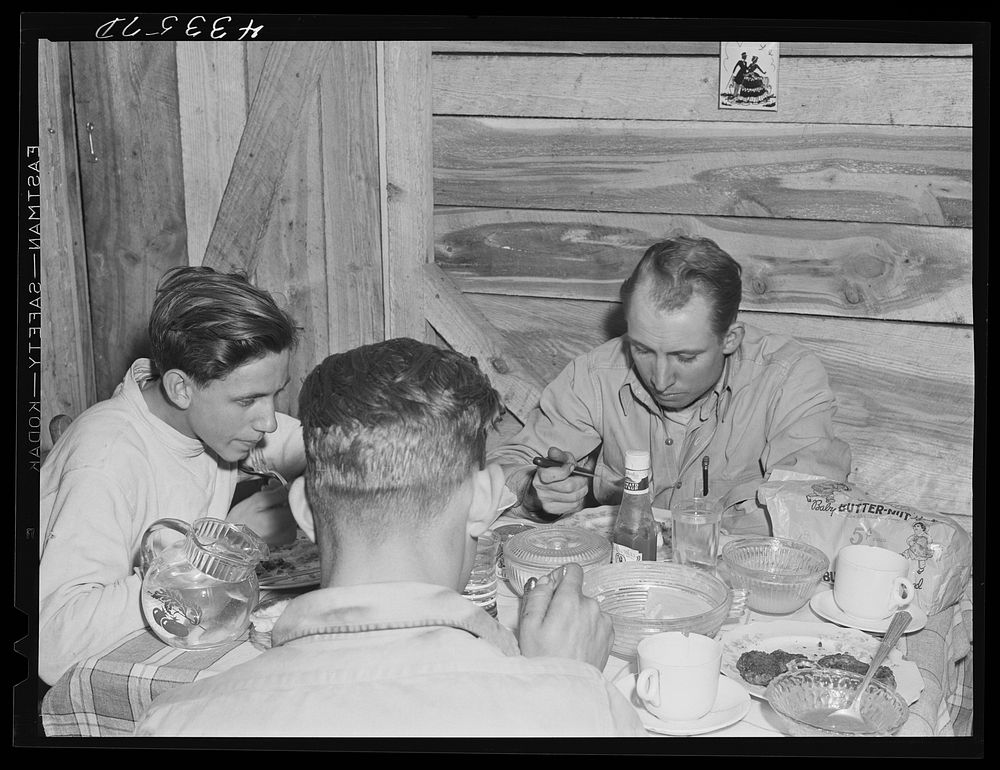 Truckers from Fort Bragg having supper in their shack near Manchester, North Carolina. Sourced from the Library of Congress.