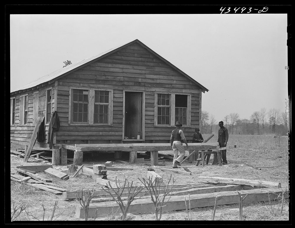 [Untitled photo, possibly related to: Building a porch for a house that had been carried out of the Santee-Cooper basin by a…