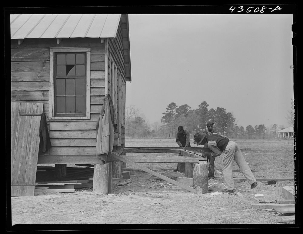 [Untitled photo, possibly related to: Building a porch for a house that had been carried out of the Santee-Cooper basin by a…