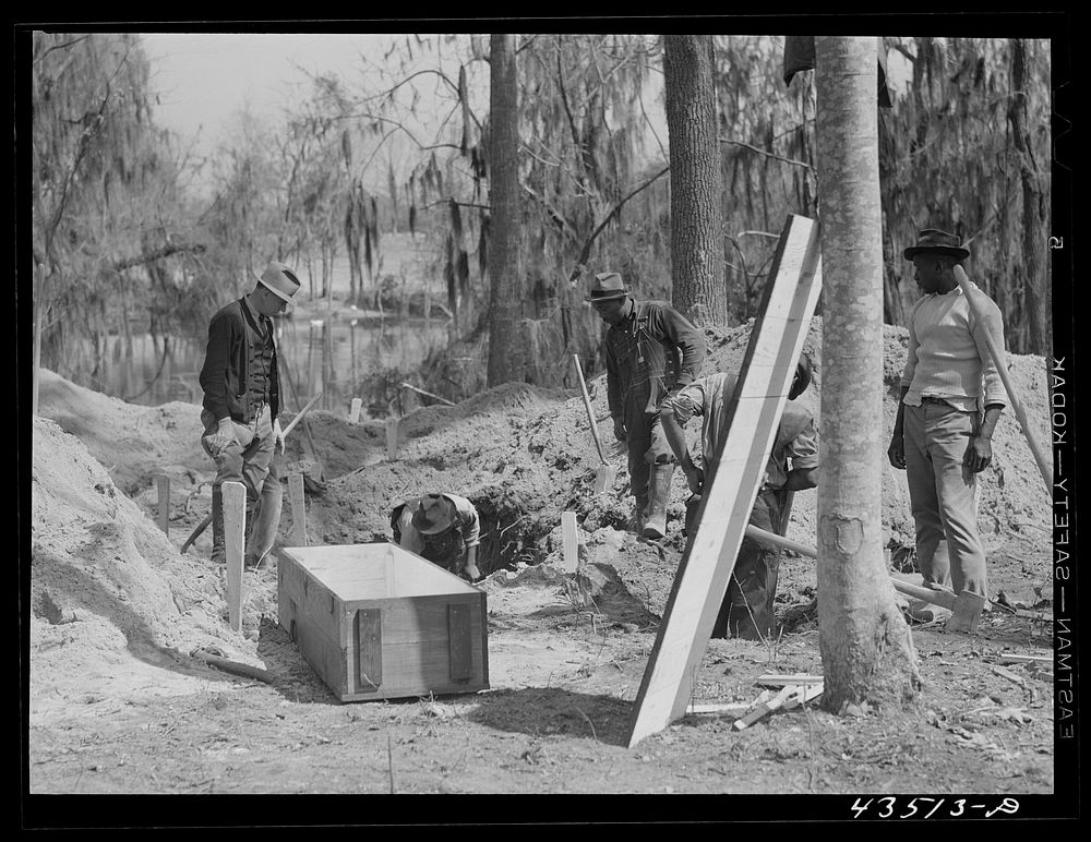 Digging out a cemetery to be moved from the Santee-Cooper basin. Near Bonneau, South Carolina. Sourced from the Library of…