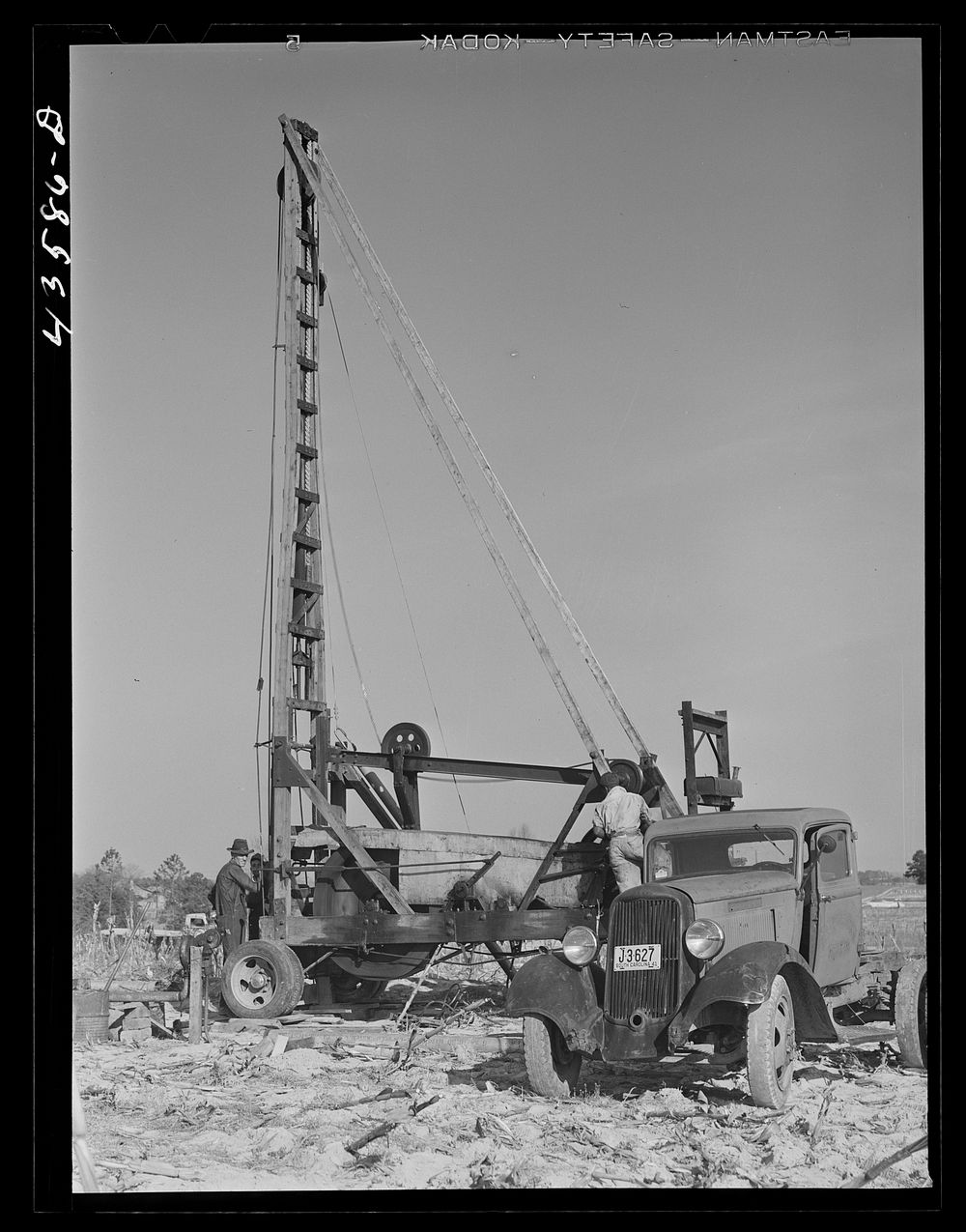 Digging a well for families moving into FSA (Farm Security Administration) prefabricated houses from the Camp Croft area.…