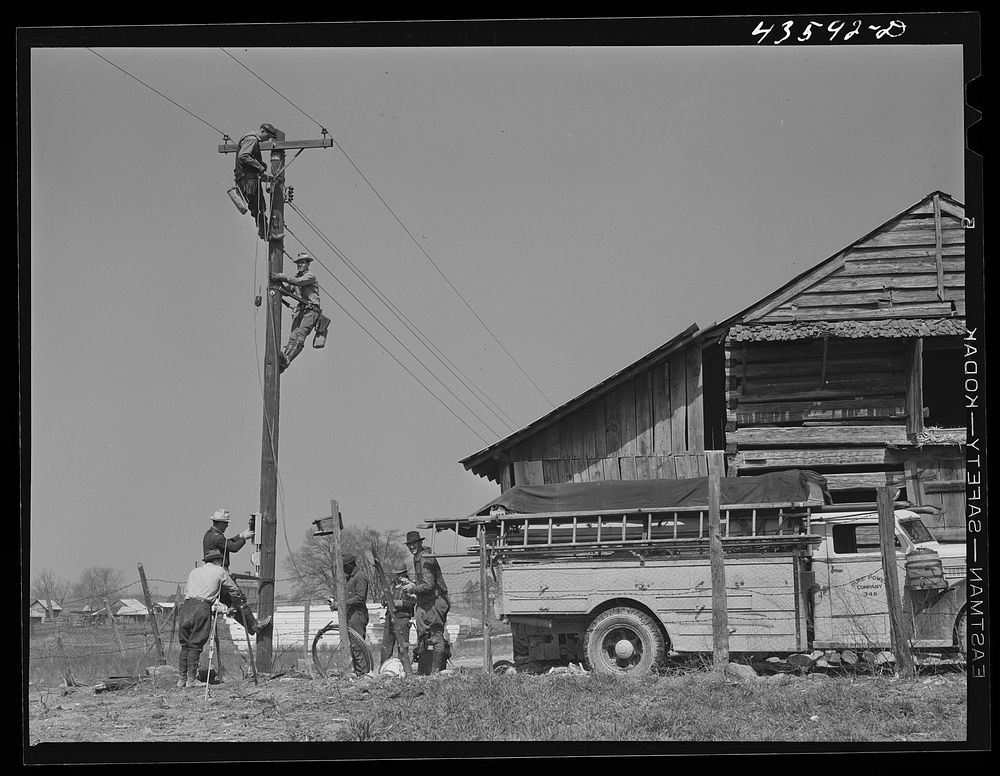 Making electricity available for prefabricated houses built by FSA (Farm Security Administration) for farmers moving out of…