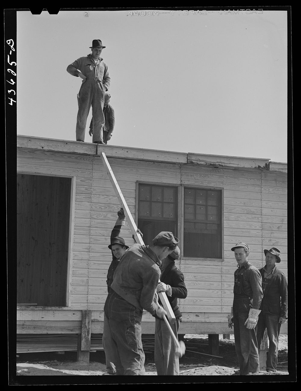 Putting the roof on a prefabricated house at the FSA (Farm Security Administration) project. Pacolet, South Carolina.…