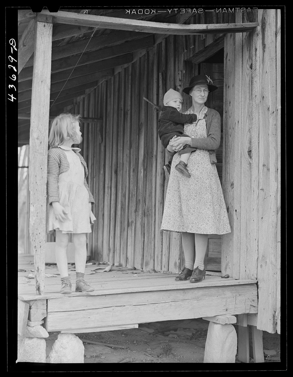 A tenant family in the Camp Croft area watching their belongings being moved out. Near Whitestone, South Carolina. Sourced…