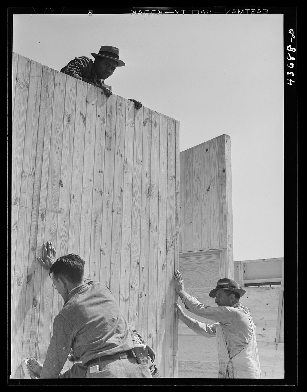 Putting up a wall in one of the prefabricated houses being built at Pacolet, South Carolina for farmers moved out of Camp…