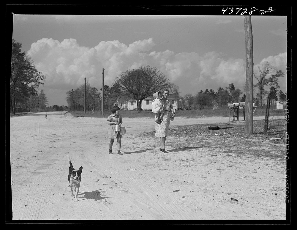 Walking down the "main street" of Hazlehurst Farms Inc. near Hazlehurst, Georgia. Sourced from the Library of Congress.