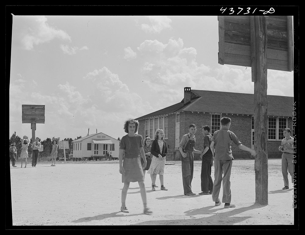 [Untitled photo, possibly related to: The white schoolhouse in the background was erected by Hazlehurst Farms Inc. to…