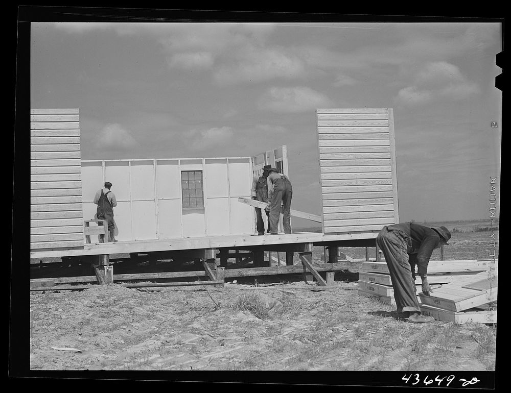 Putting up the walls on a prefabricated house at the FSA (Farm Security Administration) project in Pacolet, South Carolina.…