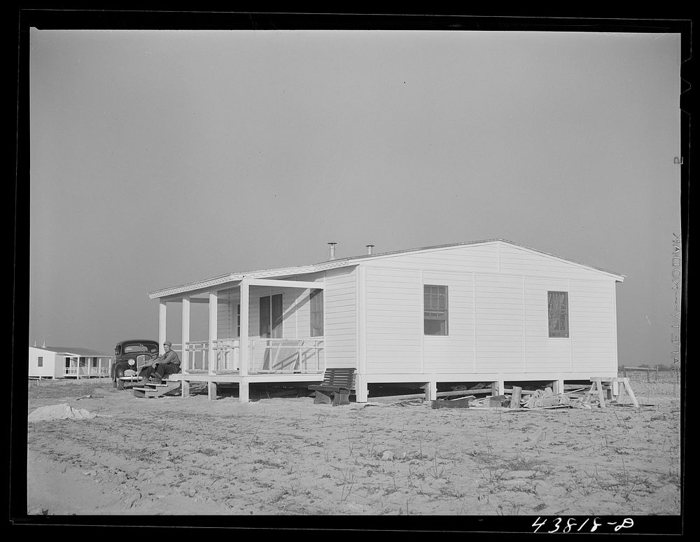 One of the completed and painted prefabricated houses for farmers moved out of the Camp Croft area at Pacolet, South…