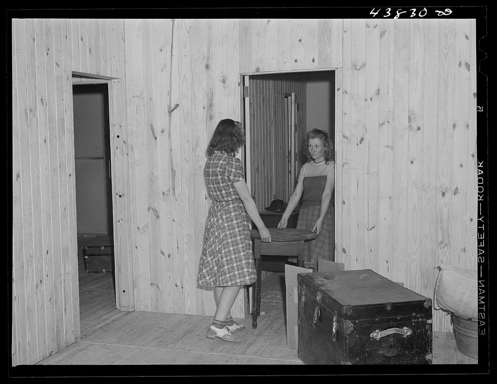 Arranging furniture at the new prefabricated house of the Lee family. Near Pacolet, South Carolina. Sourced from the Library…