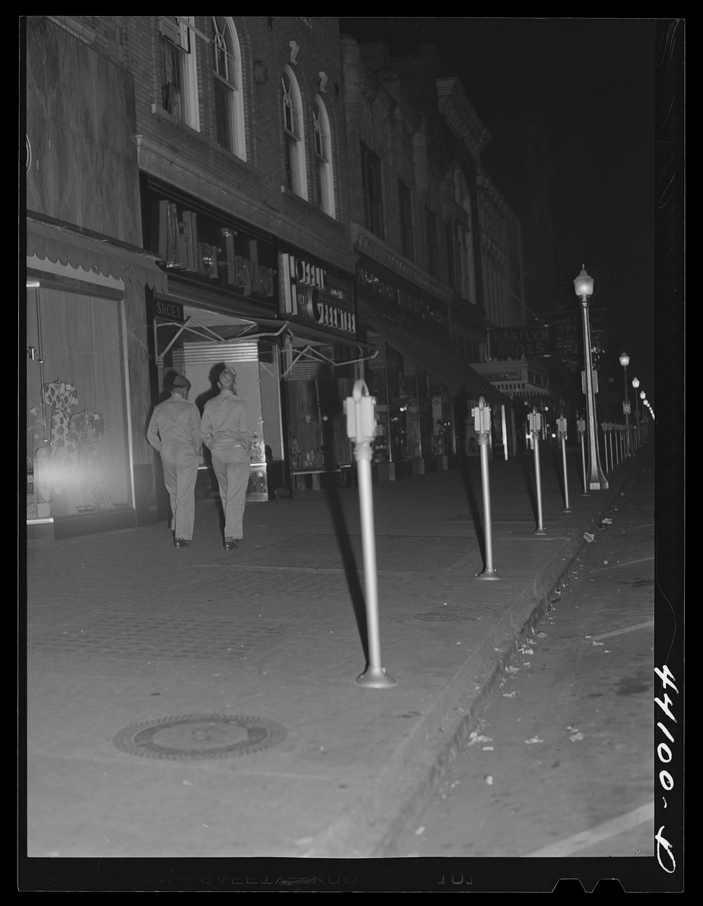 Soldiers from Fort Benning on the main street of Columbus, Georgia, at night. Sourced from the Library of Congress.