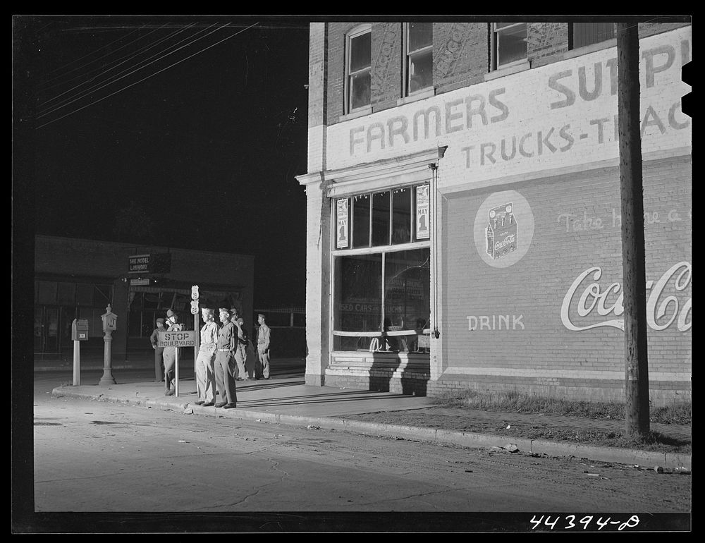 Soldiers from a nearby Army camp waiting for a bus in Anniston, Alabama. Sourced from the Library of Congress.