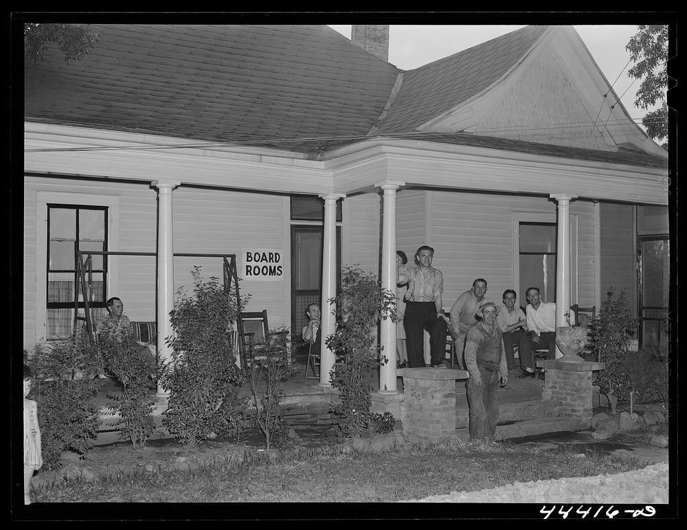 Workers from the nearby powder plant waiting for dinner at a boarding house in Childersburg, Alabama. Sourced from the…