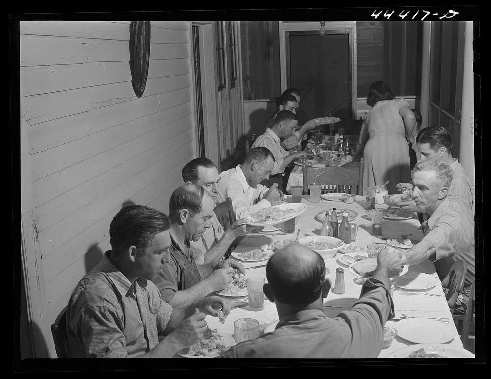 Workers from the nearby powder plant having dinner at their boarding house in Childersburg, Alabama. Sourced from the…