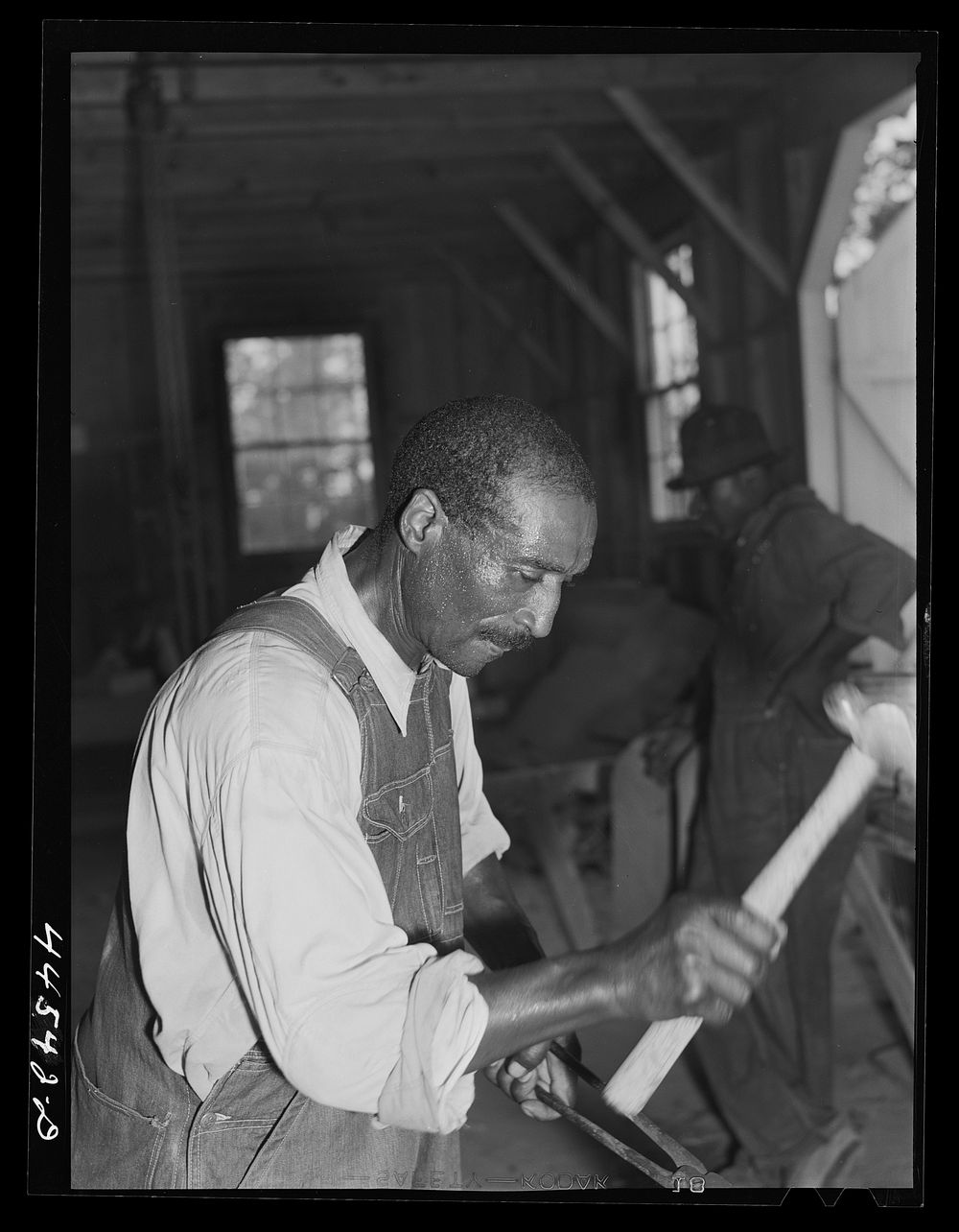 [Untitled photo, possibly related to:  farmer sharpening plow points at a new vocational school in Greene County, Georgia].…