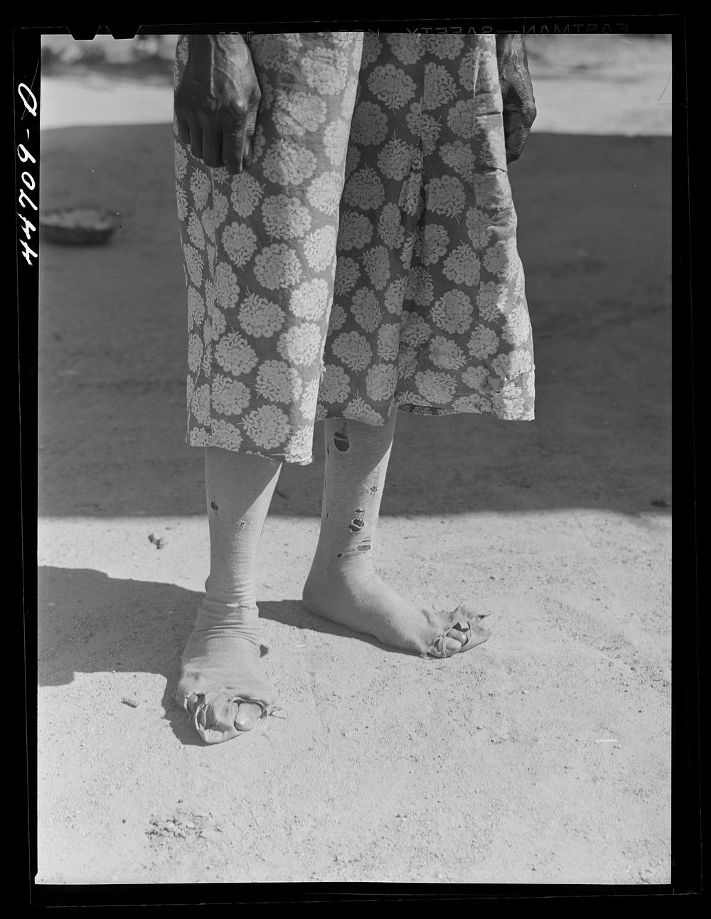 Feet of a  farm woman, who together with two children runs a rented farm. Near Woodville, Greene County Georgia. Sourced…