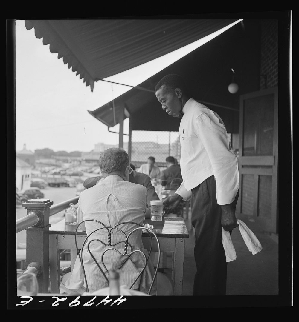  waiter in Hertzog's seafood restaurant along the waterfront. Washington, D.C.. Sourced from the Library of Congress.