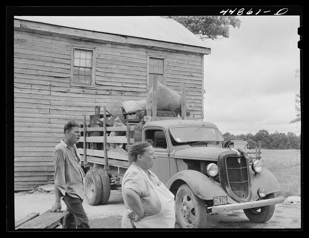 Mrs. Russell Tombs and her son are packing their household goods getting ready to move out of the area being taken over by…
