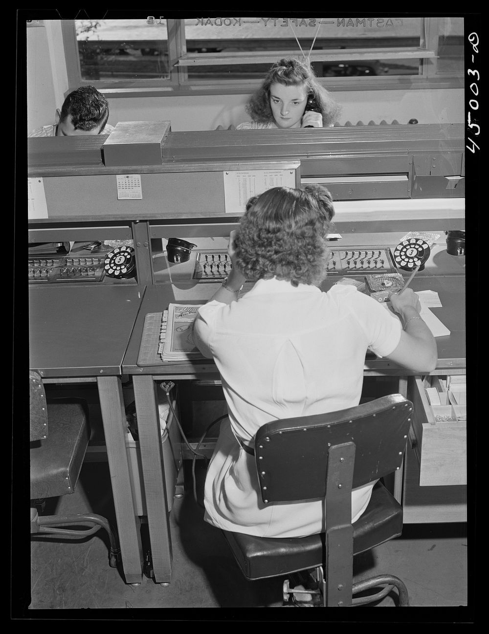 In the ticket reservations department of one of the airlines. Washington, D.C. municipal airport. Sourced from the Library…