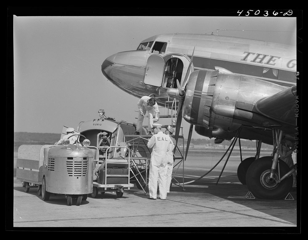 An airliner taking on baggage and fuel. Washington, D.C. municipal airport. Sourced from the Library of Congress.