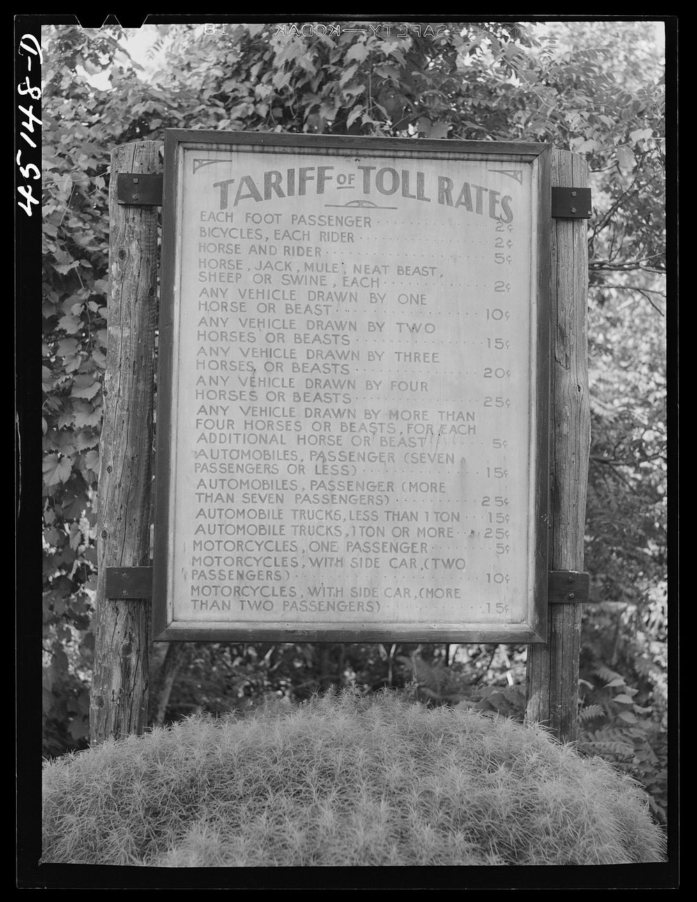 Toll rate sign on the New Hampshire side of a bridge across the Connecticut River near Springfield, Vermont. Sourced from…