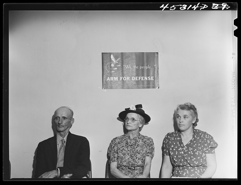 Mr. Silvester Booth, Mrs. Elsie Fournier and her daughter waiting in the New York Defense Relocation Corps office to discuss…