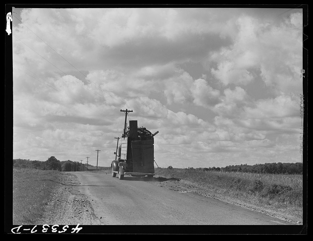 One of the many trucks to be seen carrying a farmer's belongings out of the Pine Camp expansion area. New York. Sourced from…