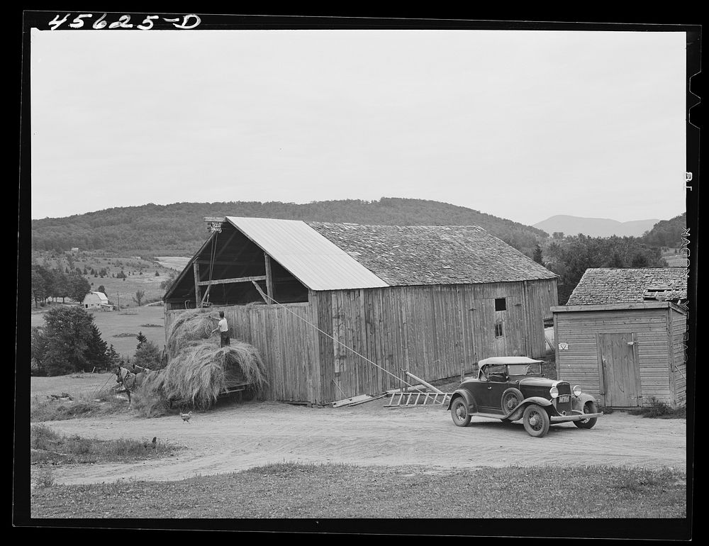 Using a car to load hay in the barn on a farm near Cambridge, Vermont. Sourced from the Library of Congress.