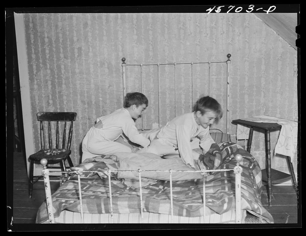 Two of the Gaynor children getting into bed on their farm near Fairfield, Vermont. Sourced from the Library of Congress.
