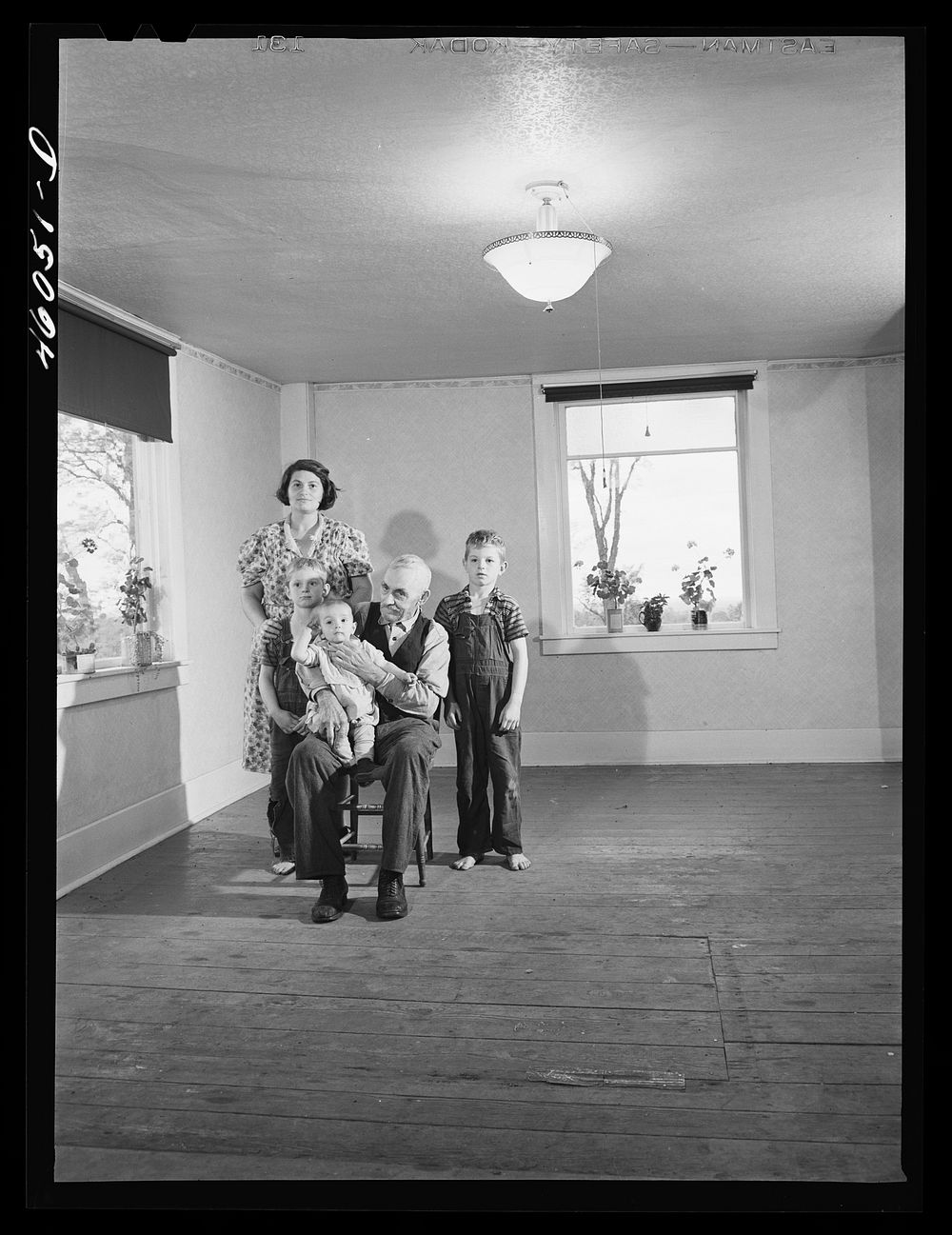 Mrs. Melvin Rivers, some of her children and her father-in-law in their new New York relocation corporation farm to which…