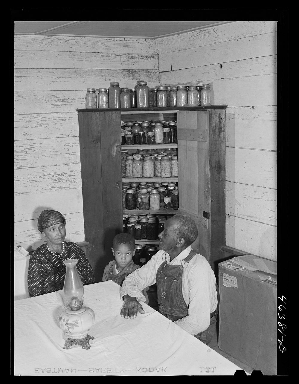 George Ward and his wife and one of his five children with some of their canned goods. FSA (Farm Security Administration)…