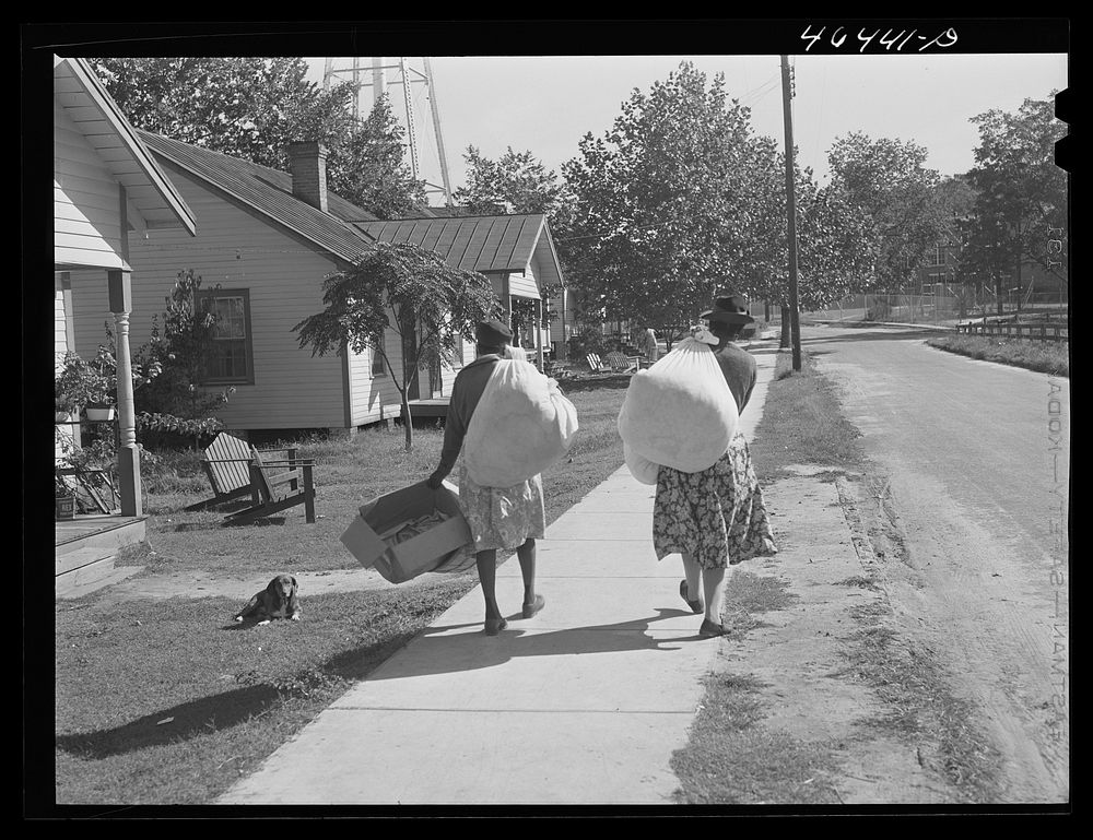 Two washwomen carry home the laundry, Greensboro, Greene County, Georgia. Sourced from the Library of Congress.